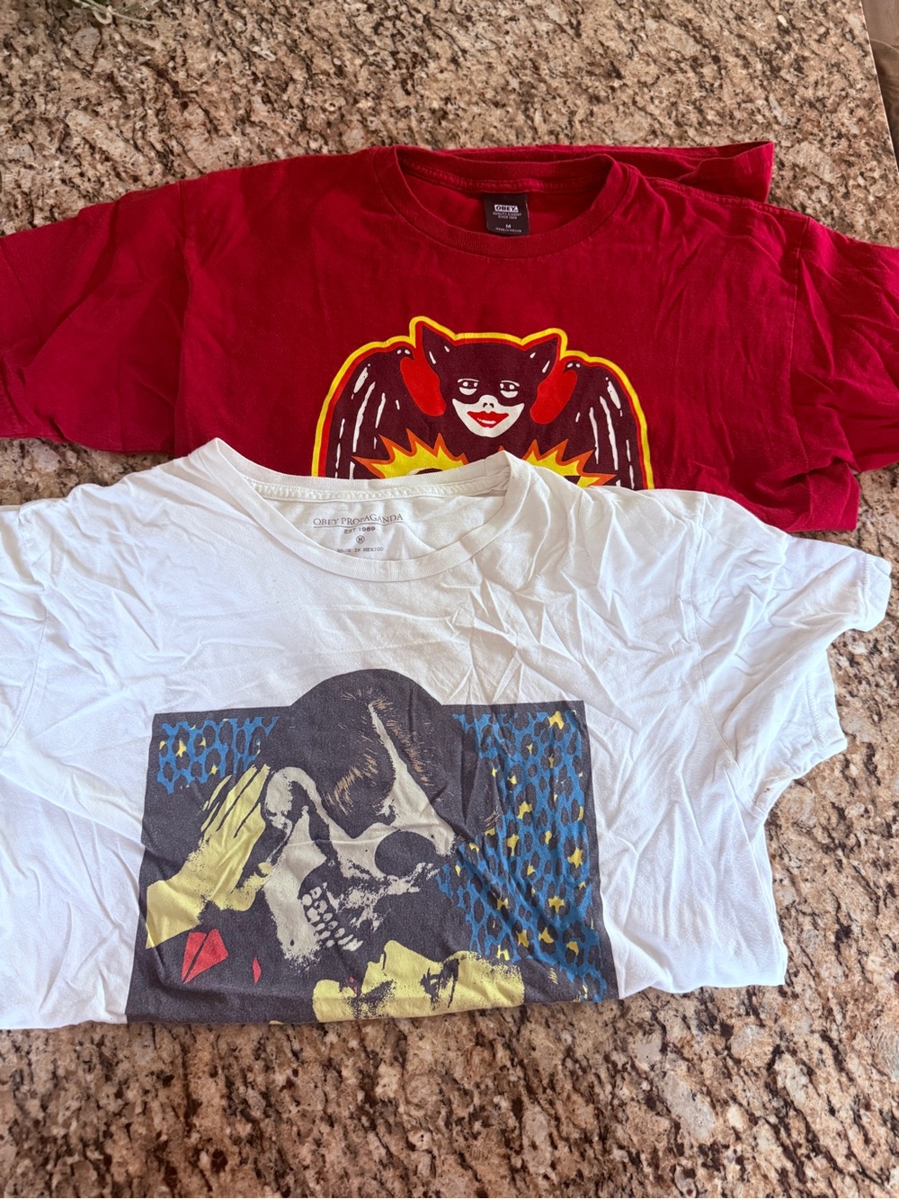 Lot of 2 Obey shirts- graphic skull embrace- Size M and Bat Girl Red Size M